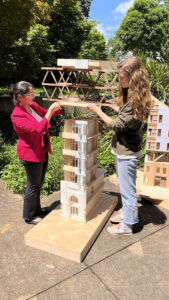 Rupan, left, and Anna Grace, right, stand with their model of 'Knox Yards.' The model surpasses the heigh of Rupan, and meets the height of Anna Grace.