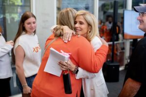 Marla Gerber, left, hugs a parent of an Architecture Class of 2027 students during the Gerber Family Weekend Tailgate.