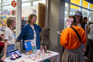 Two students from IA Collaborative speak with students at a table during 2024 Welcome Back Day.