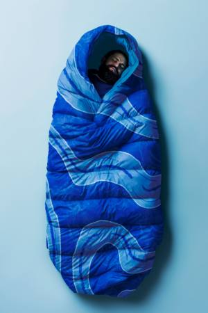 A person inside a sleeping bag branded for the OBED River