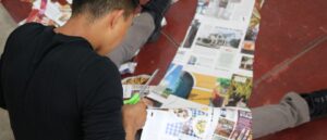 student cutting paper in shape of human