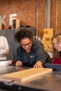 Felicia Francine Dean, Assistant Professor in the School of Interior Architecture, works with students on their project at the Fab Lab on October 31, 2023. Photo by Steven Bridges/University of Tennessee.