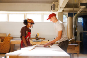 Eric Cagley, woodshop supervisor for the College of Architecture and Design, works with a student in the woodshop inside the Art and Architecture Building on September 20, 2024. Photo by Steven Bridges/University of Tennessee.