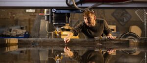A student removes cut materials from an abrasive waterjet cutter inside the UT Fab Lab during a staged photoshoot for a College of Architecture and Design annual report on October 29, 2020. Photo by Steven Bridges/University of Tennessee
